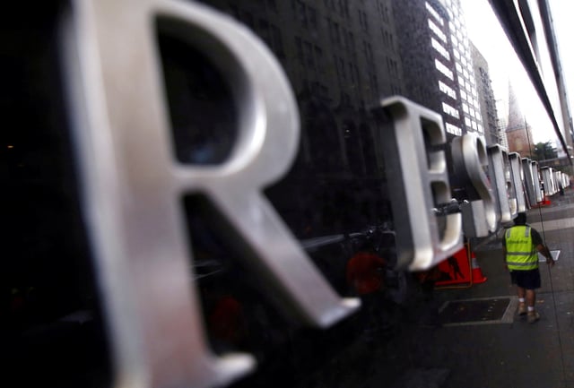 A worker is reflected in a wall of the Reserve Bank of Australia (RBA) head office in central Sydney, Australia, March 1, 2016.   REUTERS/David Gray/File Photo
