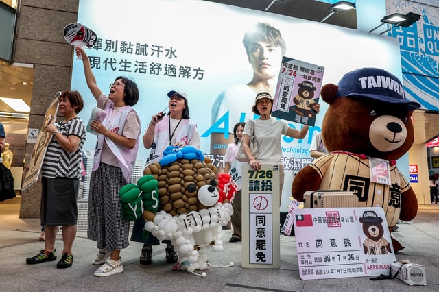 Supporters and volunteers of the recall group gather outside of a metro station shouting "Great recall, great success" in Taipei on July 22, 2025.