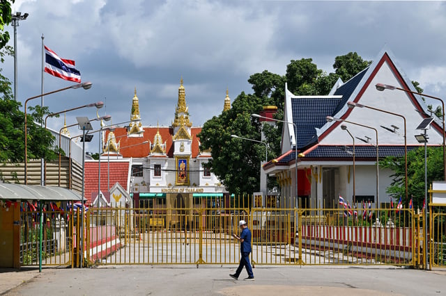 A man walks near the closed gate at Poipet International border checkpoint between Cambodia and Thailand, at Poipet town in Banteay Meanchey province on June 25, 2025.