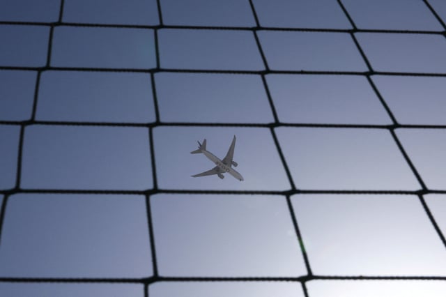 A Qatar Airways plane flies over Dubai, United Arab Emirates, August 20, 2023. REUTERS/Amr Alfiky/File Photo