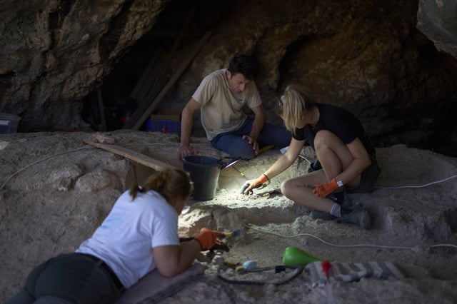 Professor of Archaeology Yossi Zaidner works in Tinshemet Cave, where archaeologists are excavating one of the world's oldest known burial sites, dating back 100,000 years, near Shoam, Israel, Tuesday, July 15, 2025. (AP Photo/Ariel Schalit)