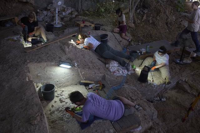 Volunteers work in Tinshemet Cave, where archaeologists are excavating one of the world's oldest known burial sites, dating back 100,000 years, near Shoam, Israel, Tuesday, July 15, 2025. (AP Photo/Ariel Schalit)