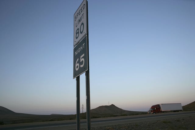 A truck passed by signs indicating the highest speed limit in the country as it traveled down Interstate 10 outside of El Paso, Texas, on Friday, July 21, 2006.