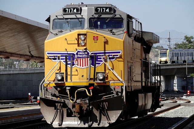 A GE AC4400CW diesel-electric locomotive, in Union Pacific livery, is seen as a Metrolink commuter train (right) arrives at Union Station in Los Angeles, California, U.S., September 15, 2022. REUTERS/Bing Guan/File photo
