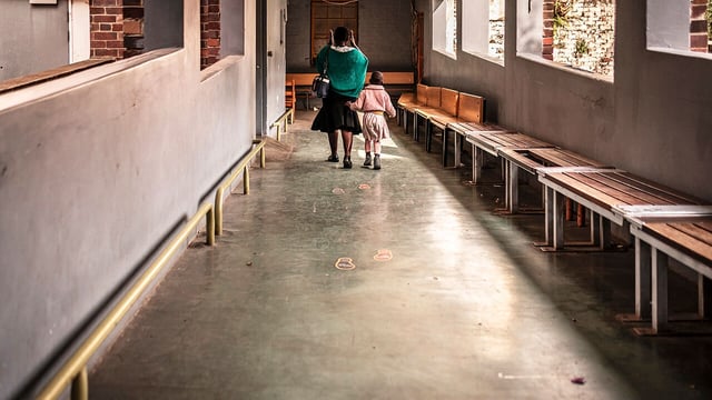A woman and child walk through a corridor at the Wits Reproductive Health and HIV Institute in Johannesburg.