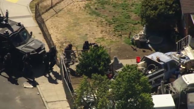 A police tactical team approaches a home in Vallejo where a suspect was thought to be barricaded Wednesday. (July 23, 2025)