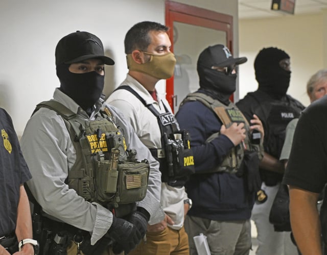 Federal agents in the hallways awaiting the detainees exiting the hearings at an immigration court in New York.