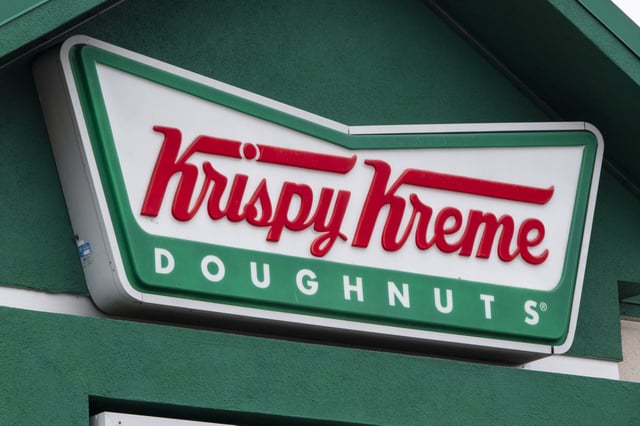 The Krispy Kreme corporate logo is displayed on a sign at their store on January 31, 2025 in San Diego, California.