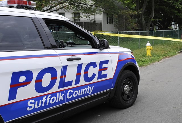 FILE - Suffolk County Police block off a street in Wyandanch,, N.Y., June 4, 2015. (AP Photo/Kathy Kmonicek, file)