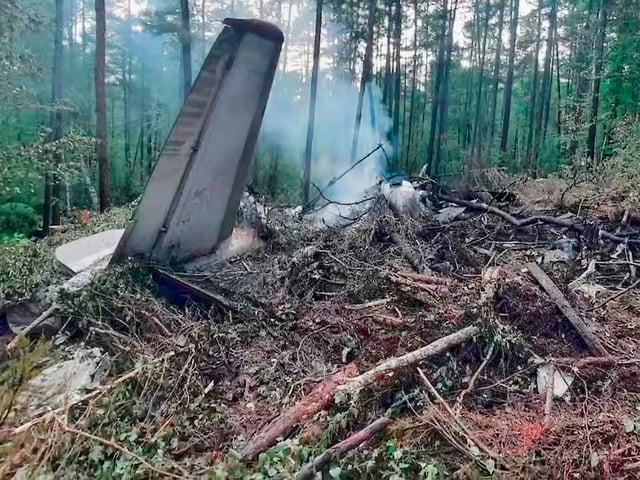 In this photo taken from video released by Russian Investigative Committee on Thursday, July 24, 2025, a view of the place of the crashed Russian An-24 passenger plane of the Siberia-based Angara Airlines while carrying 49 passengers in 15 kilometers (9 miles) south of Tynda, Far Eastern Amur region of Russia. (Russian Investigative Committee via AP)
