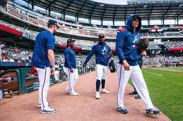 Rafael Montero #48, Enyel De Los Santos #61, Jesse Chavez #60 and Scott Blewett #63 of the Atlanta Braves walk to the bullpen before the game against the St. Louis Cardinals at Truist Park on April 23, 2025 in Atlanta, Georgia.