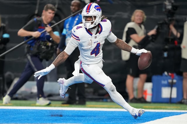James Cook #4 of the Buffalo Bills celebrates after scoring a touchdown in the third quarter against the Detroit Lions at Ford Field on December 15, 2024 in Detroit, Michigan.