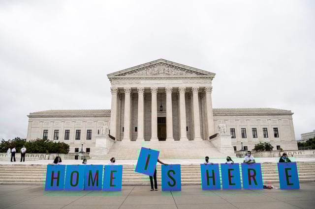 Activists hold a banner in front of the U.S. Supreme Court on June 18, 2020.