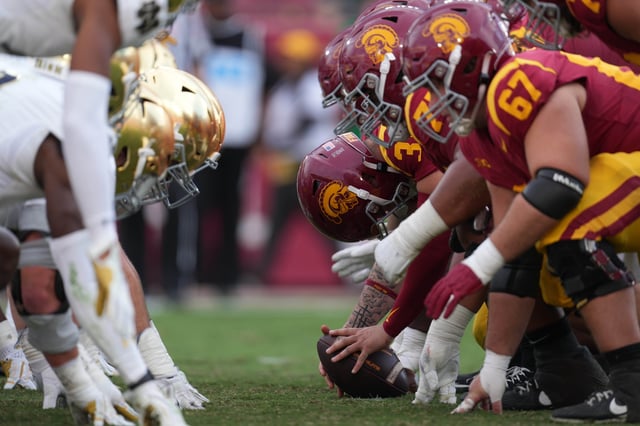 Helmets at the line of scrimmage as Southern California Trojans long snapper Hank Pepper (31) snaps the ball against the Notre Dame Fighting Irish in the second half at United Airlines Field at Los Angeles Memorial Coliseum.