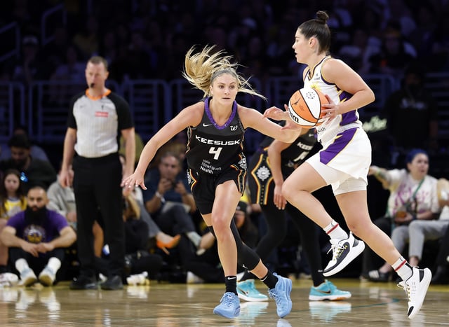 Kelsey Plum #10 of the Los Angeles Sparks controls the ball against Jacy Sheldon #4 of the Connecticut Sun in the second half at Crypto.com Arena on July 13, 2025 in Los Angeles, California.