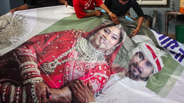 Family members of Raja Raghuvanshi cut out the picture of his wife Sonam Raghuvanshi from a poster of their marriage.