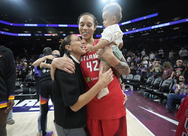 Atlanta Dream center Brittney Griner, holding her son Bash, is greeted by former Phoenix Mercury teammate Diana Taurasi after the Dream defeated the Mercury 90-79 at PHX Arena on July 23, 2025.