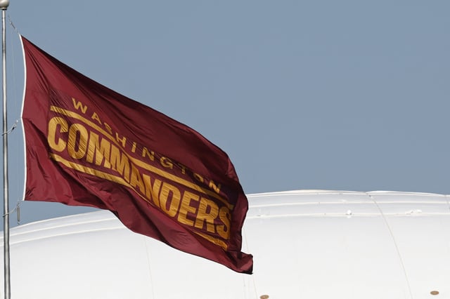 Jul 24, 2025; Ashburn, VA, USA; A Washington Commanders team flag flies at team headquarters on day two of training camp at OrthoVirginia Training Center at Commanders Park. Mandatory Credit: Geoff Burke-Imagn Images