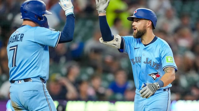 The Toronto Blue Jays’ Nathan Lukes, right, high-fives Will Wagner (7) after he hit a home run and Wagner scored against the Detroit Tigers during the eighth inning at Comerica Park on Thursday, July 24, 2025, in Detroit. (Nic Antaya/Getty Images/TNS)