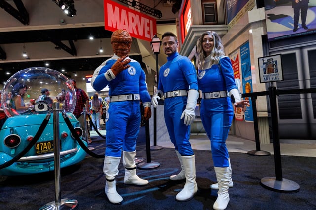 Booth attendees dressed as the Fantastic Four pose for a picture at the Marvel booth on the convention floor at Comic-Con International in San Diego, California, U.S. July 24, 2025.   REUTERS/Mike Blake