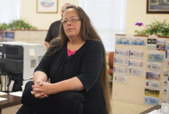 MOREHEAD, KY - SEPTEMBER 2:  Kim Davis, the Rowan County Clerk of Courts, listens to Robbie Blankenship and Jesse Cruz as they speak with her at the County Clerks Office on September 2, 2015 in Morehead, Kentucky. Citing a sincere religious objection, Davis, an Apostolic Christian, has refused to issue marriage licenses to same sex couples in defiance of a Supreme Court ruling. (Photo by Ty Wright/Getty Images)
