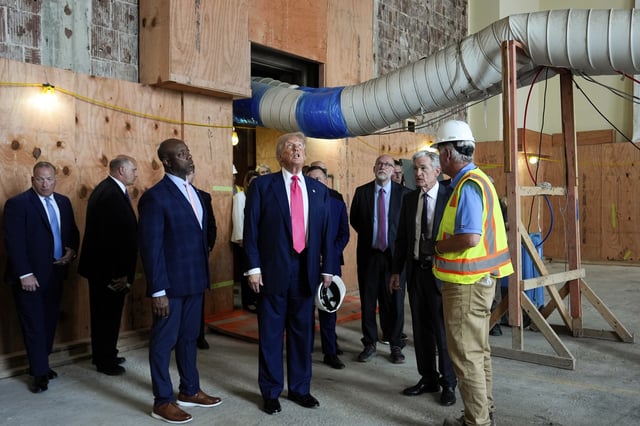 Sen. Tim Scott, R-S.C., from foreground left, President Donald Trump and Federal Reserve Chairman Jerome Powell visit the Federal Reserve, joined by Russell Vought, director of the Office of Management and Budget, in background third from right, Thursday, July 24, 2025, in Washington. (AP Photo/Julia Demaree Nikhinson)