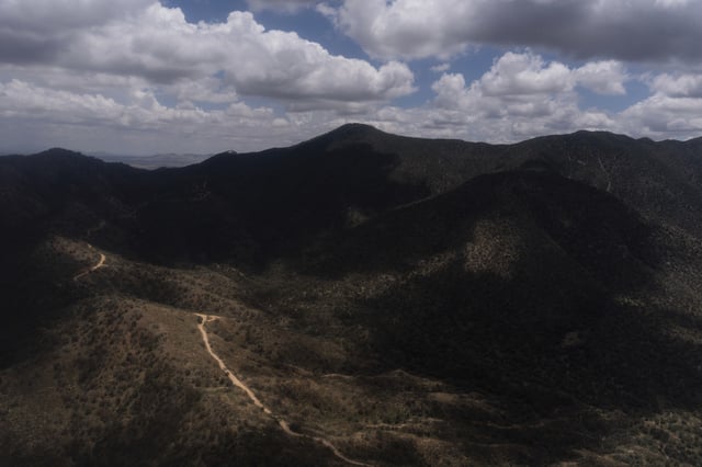 An aerial view shows mountainous terrain near Nogales, Ariz., Tuesday, July 22, 2025. (AP Photo/Jae C. Hong)