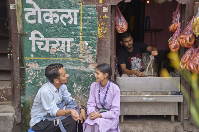 A couple talks sitting outside a tea shop at Basantapur Durbar square in Kathmandu, Nepal, Wednesday, July 23, 2025. (AP Photo/Niranjan Shrestha)