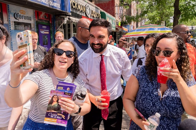 Zohran Mamdani, New York City mayoral candidate, center, greets supporters during a campaign event in New York, US, on Monday, June 23, 2025. New Yorkers will head to the polls Tuesday to choose a Democratic candidate for mayor as a sweltering heat wave engulfs the city, and with tightened security in place after the US unleashed airstrikes on Iran. Photographer: Adam Gray/Bloomberg via Getty Images