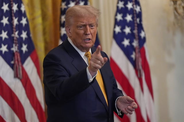 President Donald Trump gestures during a reception for Republican members of Congress in the East Room of the White House, Tuesday, July 22, 2025, in Washington.