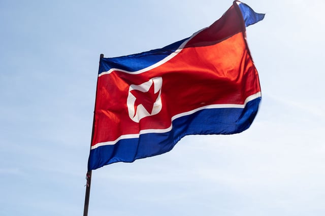 The national flag of the Democratic People's Republic of Korea (North Korea) seen during the celebration of International Workers' Day.