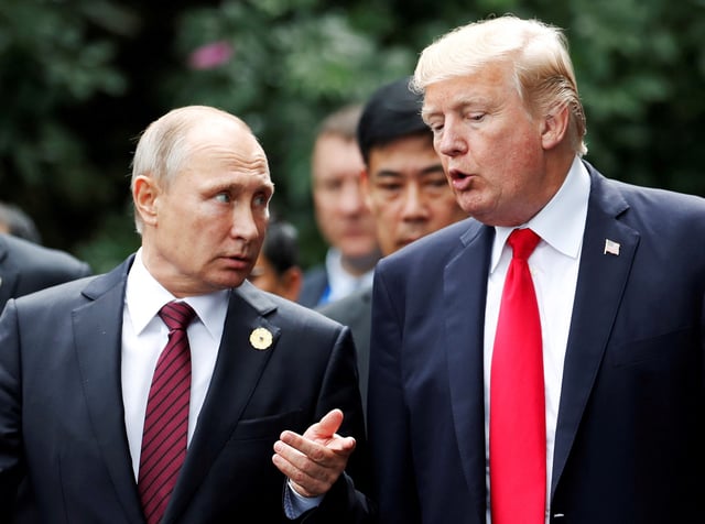 U.S. President Donald Trump and Russia's President Vladimir Putin talk during the family photo session at the APEC Summit in Danang, Vietnam November 11, 2017. REUTERS/Jorge Silva/File Photo