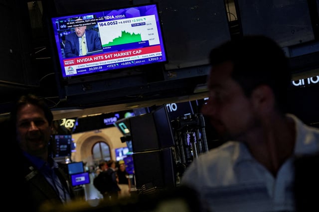 A screen displays news on "Nvidia hits $4T market cap" on the floor at the New York Stock Exchange (NYSE) in New York City, U.S., July 9, 2025. REUTERS/Jeenah Moon/File photo
