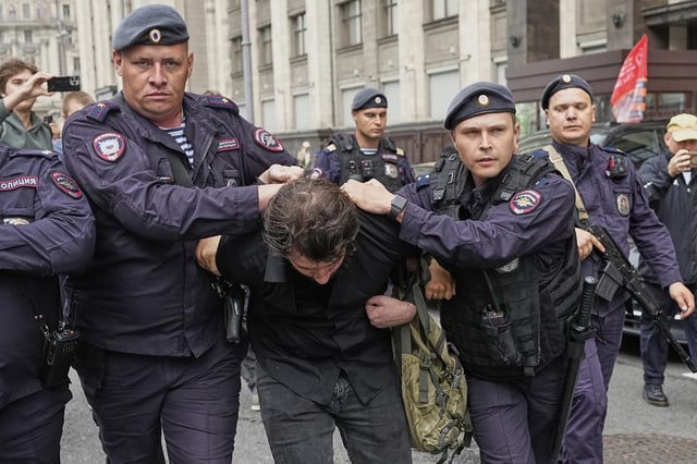 Police detain an activist in front of the State Duma, the lower house of the Russian parliament, in Moscow, Russia, Tuesday, July 22, 2025, before lawmakers approved a bill that punishes online searches for information that is deemed “extremist.” (AP Photo)