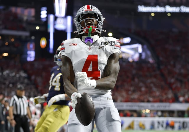 Jeremiah Smith #4 of the Ohio State Buckeyes celebrates after scoring a touchdown against the Notre Dame Fighting Irish during the second quarter in the 2025 CFP National Championship at the Mercedes-Benz Stadium on January 20, 2025 in Atlanta, Georgia.