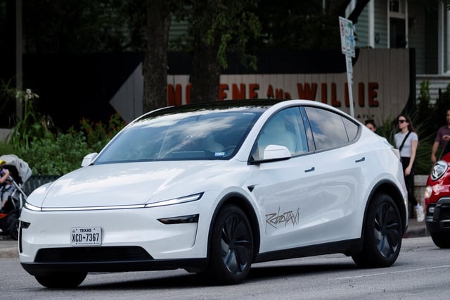A Tesla robotaxi drives on the street along South Congress Avenue in Austin, Texas, U.S., June 22, 2025. REUTERS/Joel Angel Juarez/File Photo