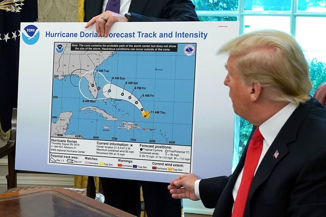 WASHINGTON, DC - SEPTEMBER 04: U.S. President Donald Trump (R) references a map held by acting Homeland Security Secretary Kevin McAleenan while talking to reporters following a briefing from officials about Hurricane Dorian in the Oval Office at the White House September 04, 2019 in Washington, DC. The map was a forecast from August 29 and appears to have been altered by a black marker to extend the hurricane's range to include Alabama. (Photo by Chip Somodevilla/Getty Images)