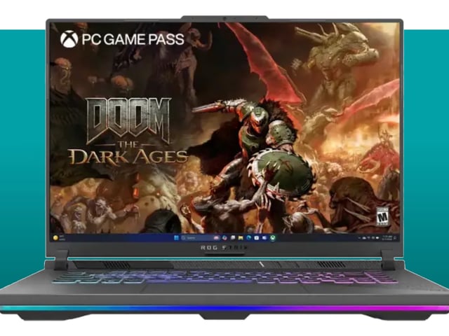 The Asus ROG Strix G16 gloats in the teal PCG deal void. Artwork for DOOM: The Dark Ages is displayed on this gaming laptop's screen.