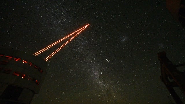 Picture of the powerful lasers emerging from the new laser system on Unit Telescope 4 of ESO's Very Large Telescope at ESO's Paranal Observatory on Paranal Hill in Chile's Antofagasta Region