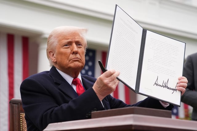 President Donald Trump displays a signed executive order imposing tariffs on imported goods during a “Make America Wealthy Again” trade announcement event in the Rose Garden at the White House on April 2, 2025 in Washington, DC.