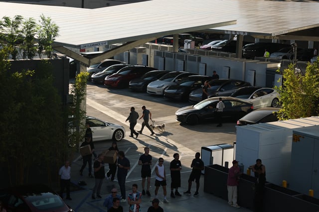 Tesla electric vehicles charge during the opening of the Tesla Diner and Drive-In restaurant and Supercharger on Santa Monica Blvd in the Hollywood neighborhood Los Angeles, California on July 21, 2025.