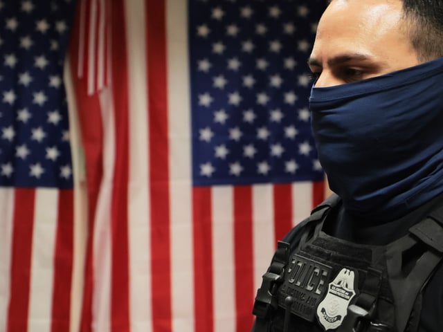 NEW YORK, NEW YORK - JULY 21: Federal agents patrol the halls of immigration court at the Jacob K. Javitz Federal Building on July 21, 2025 in New York City. Lawmakers in New York are introducing a bill that would ban law enforcement officers, including federal U.S. Immigration and Customs Enforcement (ICE) agents, from wearing masks. The bill, sponsored by Assemblymember Tony Simone, would be called the Mandating End of Lawless Tactics (MELT) Act. (Photo by Michael M. Santiago/Getty Images)