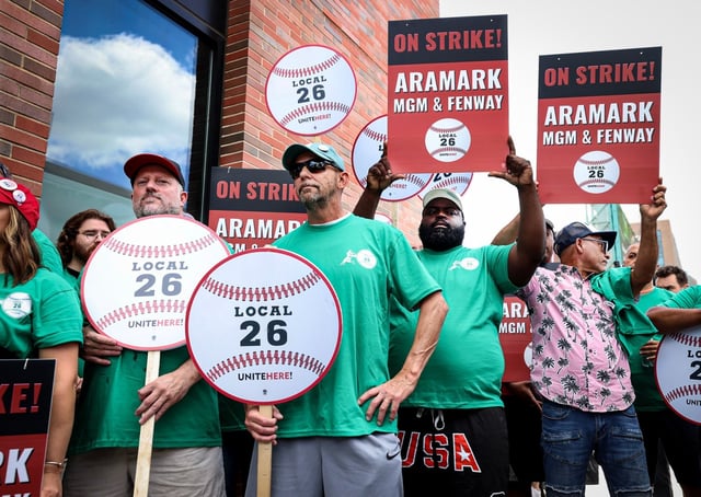 Aramark employees and members of UNITE HERE Local 26 at Fenway Park and MGM Music Hall assemble picket signs on Ipswich Street in Boston on Wednesday. (Mark Stockwell/Boston Herald)