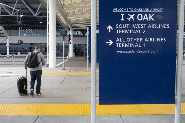 FILE: A traveler walks towards a Southwest Airlines check-in area at the Oakland International Airport in Oakland, California, US, on Tuesday, Sept. 19, 2023.