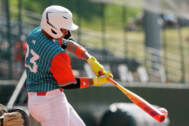 Abraham Lucena #23 of the Latin America Region team from Barquisimeto, Venezuela hits a single in the fourth inning against the Southwest Region team from Boerne, Texas during the Little League World Series Consolation Game at Howard J. Lamade Stadium on August 25, 2024 in South Williamsport, Pennsylvania. Image for illustration purposes only.