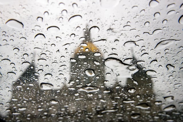 In Hartford a downpour hits against the sunroof of a car with the states capital in the distance. The National Weather Service upgraded the severe thunderstorm risk across western Massachusetts and Connecticut on Monday afternoon. (Douglas Hook / Hartford Courant)