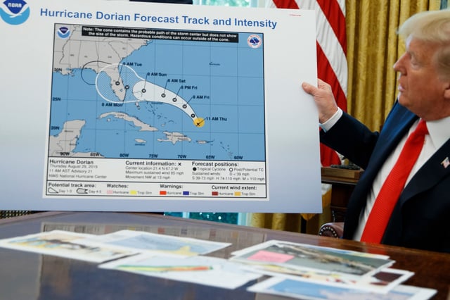President Donald Trump talks with reporters after receiving a briefing on Hurricane Dorian in the Oval Office on Sept. 4, 2019.
