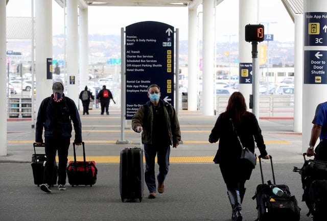 Travelers prepare to enter Oakland International Airport. The Port of Oakland officially renamed its airport as Oakland San Francisco Bay Airport on Thursday, reigniting a legal dispute with San Francisco.