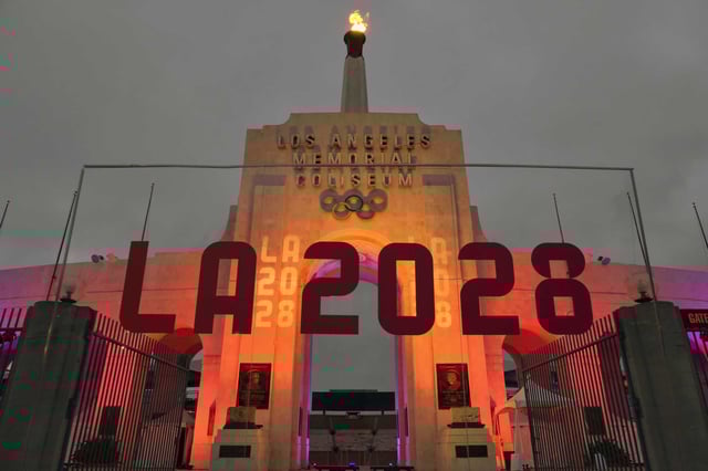 An LA 2028 sign is seen in front of the Olympic cauldron at the Los Angeles Memorial Coliseum, Wednesday, Sept. 13, 2017.