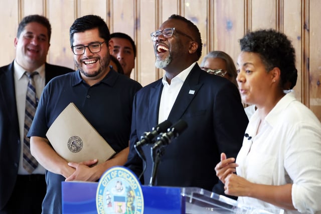 Chicago Park District Superintendent Carlos Ramirez-Rosa, from left, and Chicago Mayor Brandon Johnson laugh at a joke made by Chicago Ald. Maria Hadden, 49th,   during a press conference at Loyola Beach Park in Chicago after the mayor spent time visiting various sites in the 49th Ward on July 25, 2025. (Terrence Antonio James/Chicago Tribune)